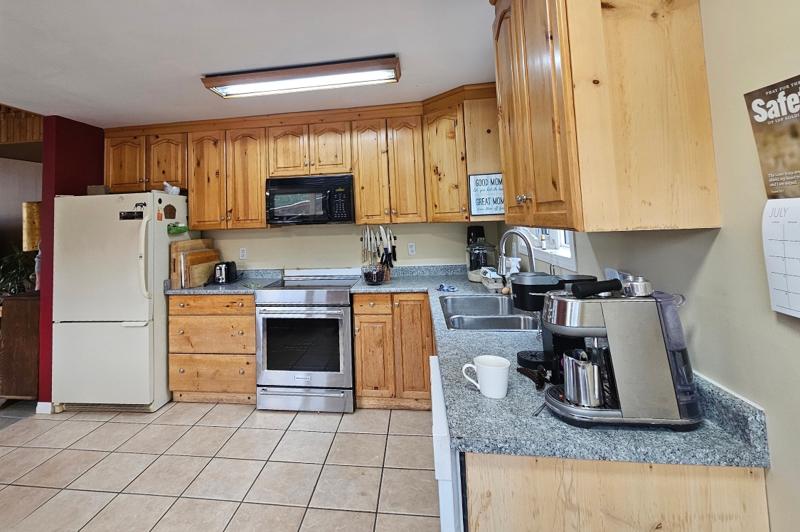 228A Alaska Highway, Haines Junction, Yukon — open-concept living, kitchen and dining with mountain views